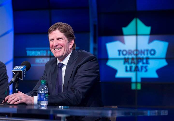 Toronto Maple Leafs' new head coach Mike Babcock laughs during a press conference in Toronto on Thursday, May 21, 2015. THE CANADIAN PRESS/Darren Calabrese.