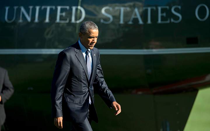 President Barack Obama walks on the South Lawn as he arrives the White House in Washington, Friday, Sept. 11, 2015.  