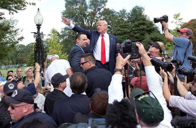 Republican presidential candidate Donald Trump waves to the crowd as he leaves a rally organized by Tea Party Patriots in on Capitol Hill in Washington, Wednesday, Sept. 9, 2015.