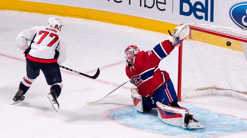 Washington Capitals' T.J. Oshie scores the winning goal past Montreal Canadiens goalie Mike Condon during the shoot out in NHL hockey action Thursday, September 24, 2015 in Montreal. The Capitals beat the Canadiens 4-3. 