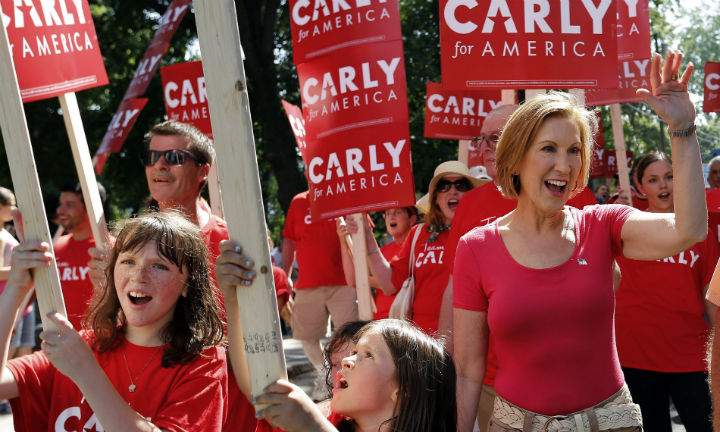 Republican presidential candidate Carly Fiorina, the former Hewlett-Packard chief executive waves as she and supporters march in the Labor Day parade Monday, Sept. 7, 2015, in Milford, N.H.
