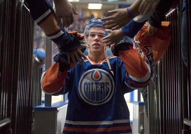 Edmonton Oilers' Connor McDavid leaves the ice after being name the first star of the game as the Oilers defeated the Minnesota Wild in NHL pre-season hockey game in Saskatoon, Saturday, September 26, 2015. McDavid is already helping the Edmonton Oilers off the ice.Even before the start of the NHL regular season, the addition of the top draft pick has seen Oilers' ticket sales climb 131 per cent compared to last year on the secondary market, according to StubHub.com. 