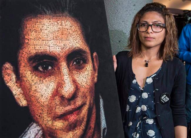Ensaf Haidar stands next to a poster of a book of articles written by the imprisoned Saudi blogger and Haidar's husband, Raif Badawi, on June 16, 2015 in Montreal.