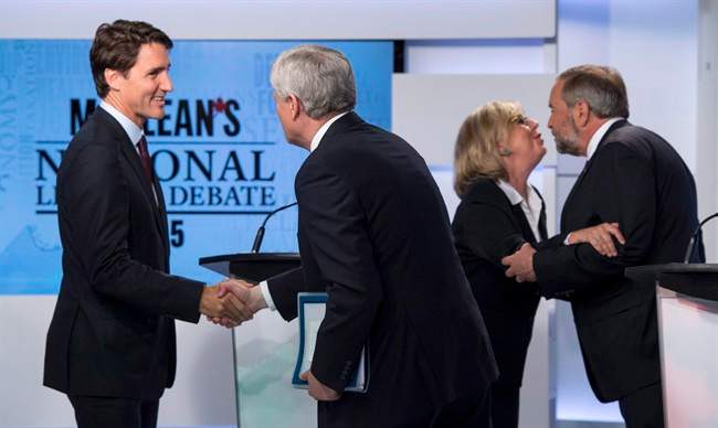 Liberal leader Justin Trudeau, left, shakes hands with Conservative leader Stephen Harper as Green party leader Elizabeth May and NDP leader Thomas Mulcair embrace following the first leaders debate Thursday, August 6, 2015 in Toronto.