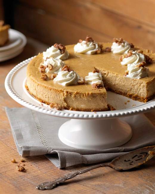 This elegant pumpkin cheesecake, decorated with whipped cream and sweetened walnuts, is a delicious way to end a holiday feast or dinner party. 
