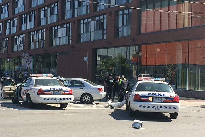Police apprehended one suspect by ramming a silver Toyota Corolla after a brazen daytime shooting in the Distillery District on Sept. 16, 2015.