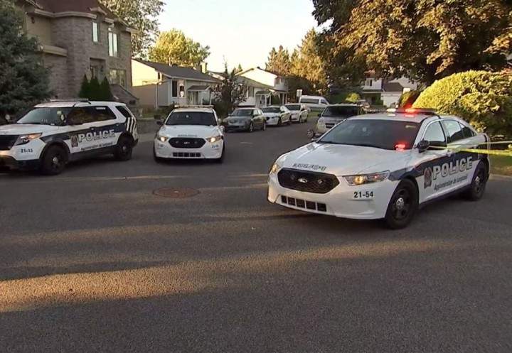 Police officers arrive on the scene after a girl was bitten by a dog in Brossard, Sunday, September 20, 2015.