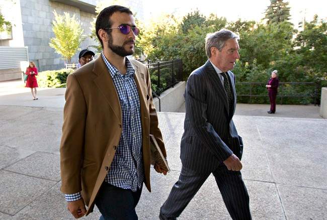 Dennis Edney right, arrives at court hearing in Edmonton, Alta., with Omar Khadr on Friday, September 11, 2015. THE CANADIAN PRESS/Jason Franson