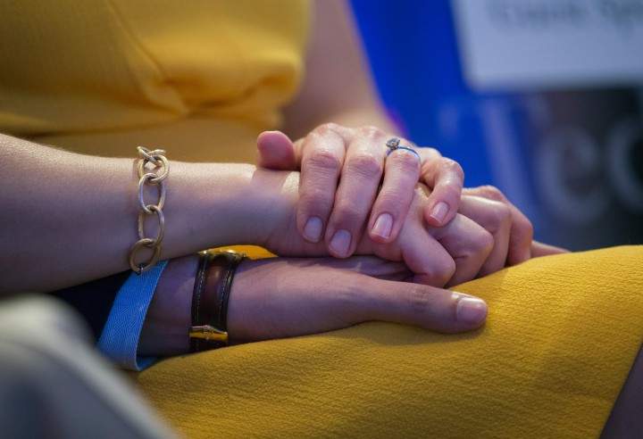 A couple holding hands.