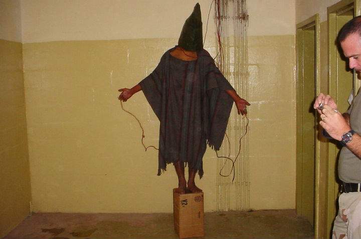 This late 2003 file photo, an image obtained by The Associated Press, shows an unidentified detainee standing on a box with a bag on his head and wires attached to him in the Abu Ghraib prison in Baghdad, Iraq.