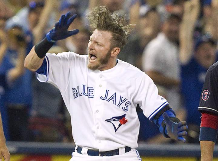 Toronto Blue Jays' Josh Donaldson celebrates after sliding safely into third base with a triple against the Cleveland Indians during fifth inning AL baseball action in Toronto on Monday, August 31, 2015. 