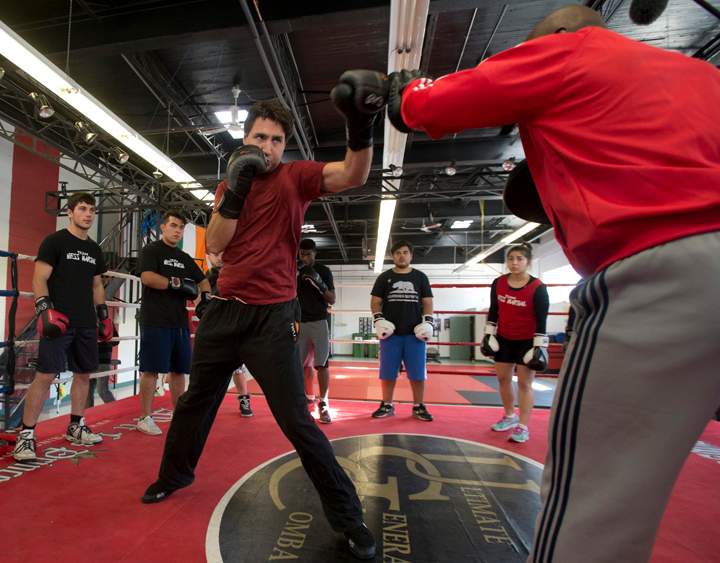 Liberal leader Justin Trudeau boxes with trainer Ali Nestor during a campaign stop in Montreal, Wednesday September 23, 2015. THE CANADIAN PRESS/Adrian Wyld.