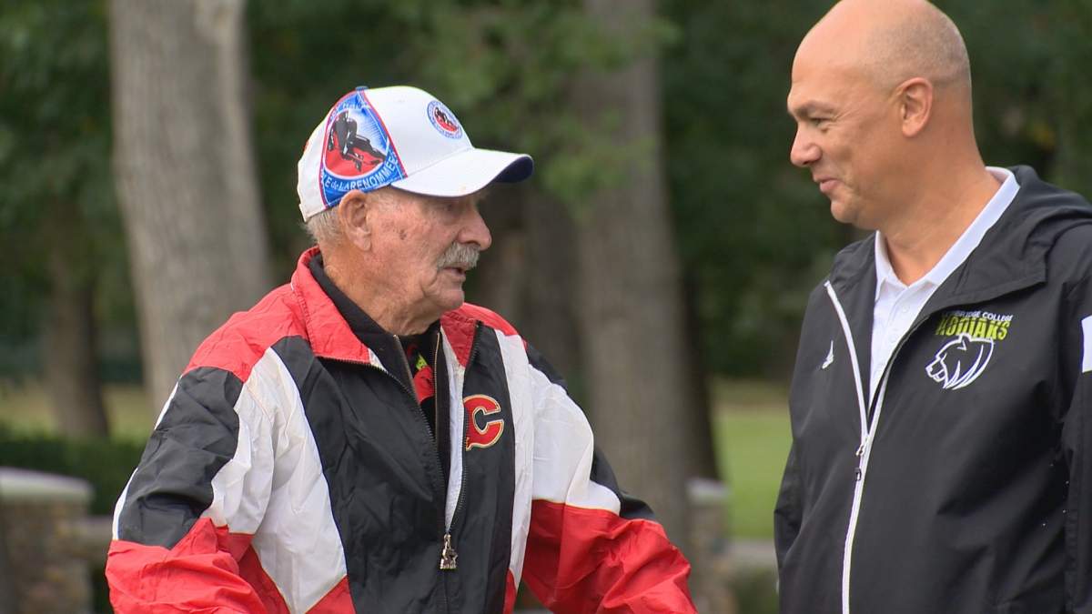 Jim "Bearcat" Murray (left) speaks with Lethbridge College Athletics manager Todd Caughlin (right) at the Lethbridge College Golf Tournament.