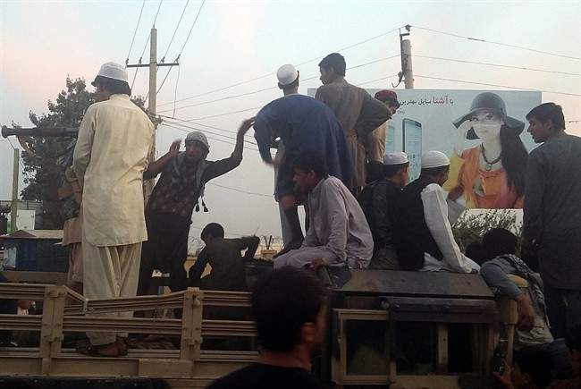 Taliban fighters and young men take over an army truck on a street in Kunduz, north of Kabul, Afghanistan, Monday, Sept. 28, 2015. The Taliban captured the northern Afghan city of Kunduz in a massive assault Monday involving hundreds of fighters, and now control a major urban area for the first time since the 2001 U.S.-led invasion. 
