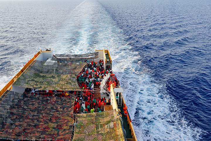 Migrants crowd the bridge of the Norwegian Siem Pilot ship sailing along the Mediterranean Sea, Wednesday, Sept. 2, 2015.