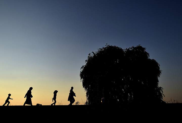 Syrian refugees and migrants along a railway line as they try to cross from Serbia into Hungary near Horgos on September 1, 2015.