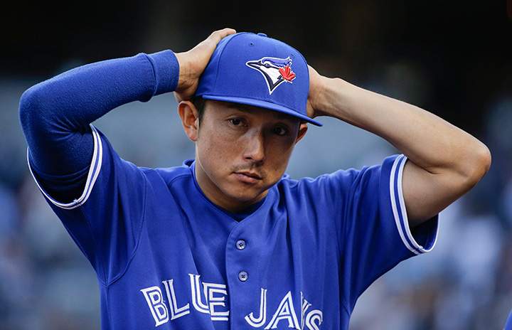 Toronto Blue Jays' Munenori Kawasaki adjusts his cap as he walks to the dugout before Toronto's baseball game against the New York Yankees, Friday, Aug. 7, 2015, in New York. 