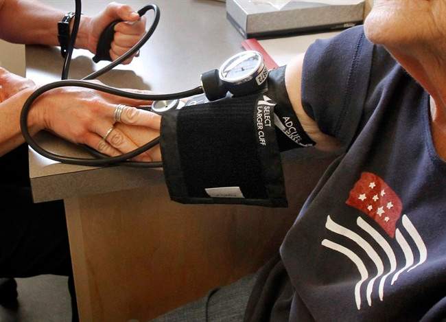 A patient has her blood pressure checked by registered nurse in Plainfield, Vt.  