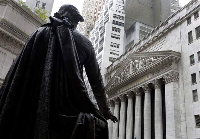 The statue of George Washington, on the steps of Federal Hall, faces the facade of the New York Stock Exchange. World stock markets await word of whether or not U.S. interests are about to tick higher for the first time in nearly a decade.