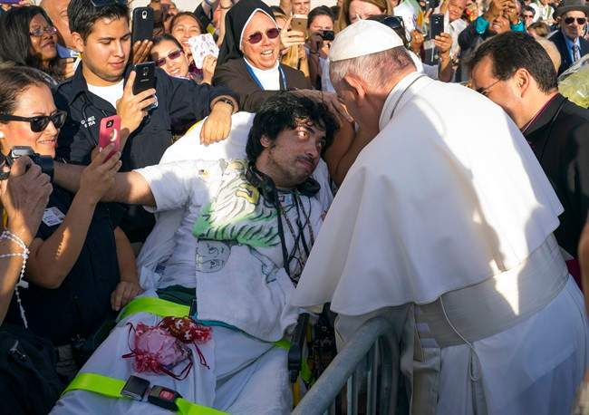 Pope Francis engages well-wishers including Gerard Gubatan, of the Brooklyn borough of New York, center left, after arriving at John F. Kennedy International Airport Thursday, Sept. 24, 2015, in New York. 