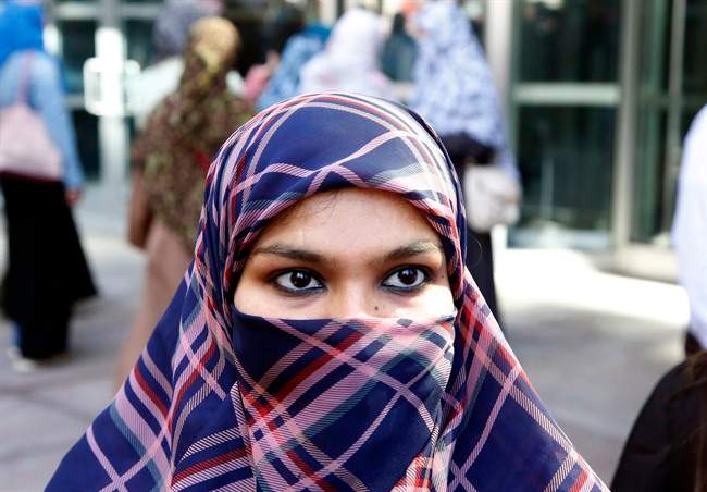 Zunera Ishaq talks to reporters outside the Federal Court of Appeal after her case was heard on whether she can wear a niqab while taking her citizenship oath, in Ottawa on Tuesday, September 15, 2015.