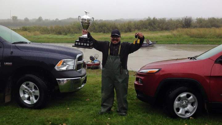 Ronald Highway poses with the two vehicles he won at the Senator Pierre Settee Memorial Heaviest Walleye Derby in Cumberland House.