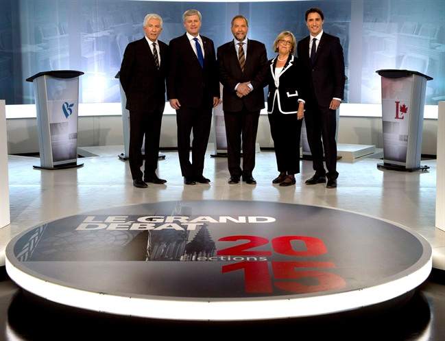 Bloc Quebecois Leader Gilles Duceppe, from left to right, Conservative Leader Stephen Harper, NDP Leader Tom Mulcair, Green party Leader Elizabeth May and Liberal Leader Justin Trudeau pose for photos before the French-language leaders' debate Thursday, September 24, 2015, in Montreal.