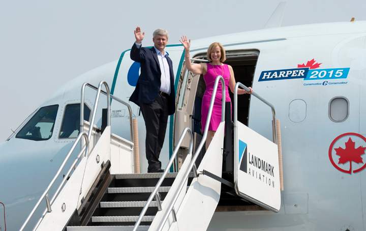 Conservative Leader Stephen Harper and his wife Laureen wave as they board the  party campaign plane after meeting the crew at the airport in Toronto,  Tuesday, September 1, 2015.   