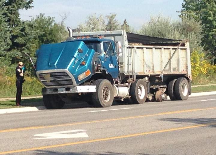 Peel police investigate after a tire flew off a dump truck and struck a woman in Mississauga on Sept. 18, 2015.