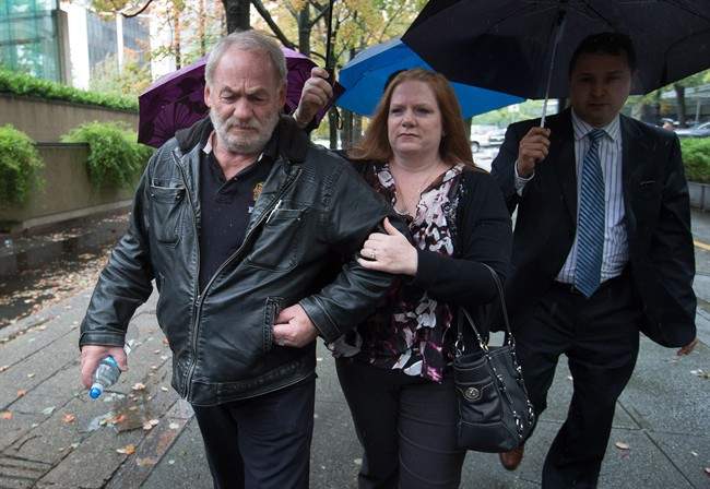 Ivan Henry, left, who was wrongfully convicted of sexual assault in 1983, and his daughter Tanya Olivares, centre, leave B.C. Supreme Court during a lunch break in Vancouver, B.C., on Monday August 31, 2015. Henry is suing prosecutors for allegedly breaching his charter rights after he was acquitted in 2010 of 10 sexual-assault convictions. 