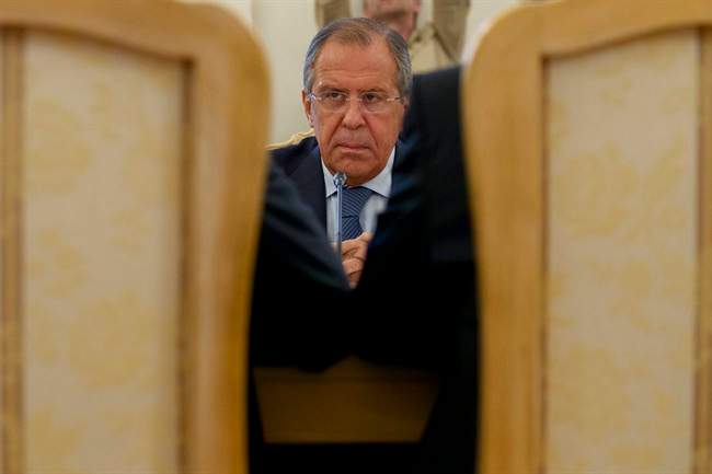 Russian Foreign Minister Sergey Lavrov listens to his counterparts Ibrahim Gandour, from Sudan, left, and Benjamin Barnaba, from South Sudan, right, during their trilateral meeting in Moscow, Russia, on Thursday, Sept. 10, 2015. 