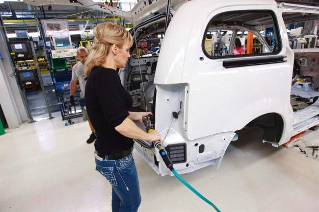 A worker on the production line at Chrysler's assembly plant in Windsor, Ontario, works on a minivan on Tuesday, January 18, 2011.