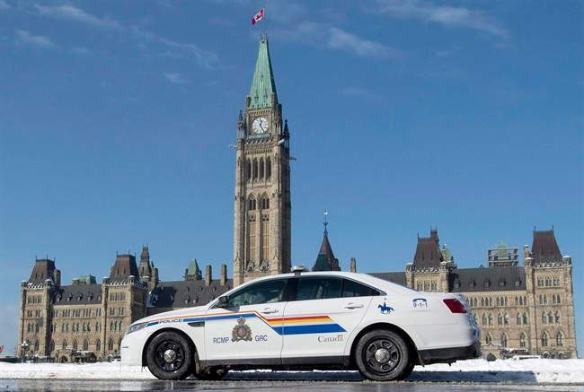 An RCMP police car sits outside the Parliament buildings on Parliament Hill in Ottawa, Friday, February 6, 2015.