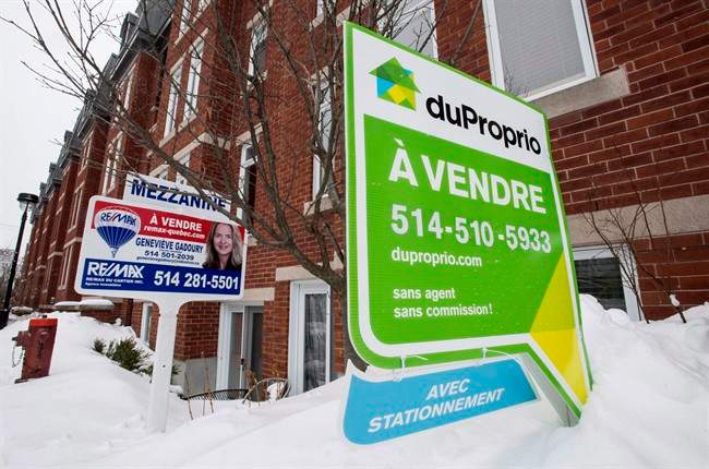 For sale signs are seen in front of a Montreal condominium.