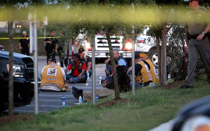 Police detain and watch members of various motorcycle clubs outside the Twin Peaks restaurant in Waco, Texas, Sunday, May 17, 2015. 