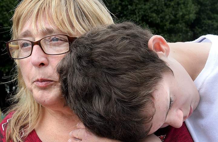 Richard Glossip’s sister, Nancy Ogden, left and her grandson Kevin Glossip embrace outside Oklahoma State Penitentiary in McAlester, Okla., Wednesday, Sept. 30, 2015.