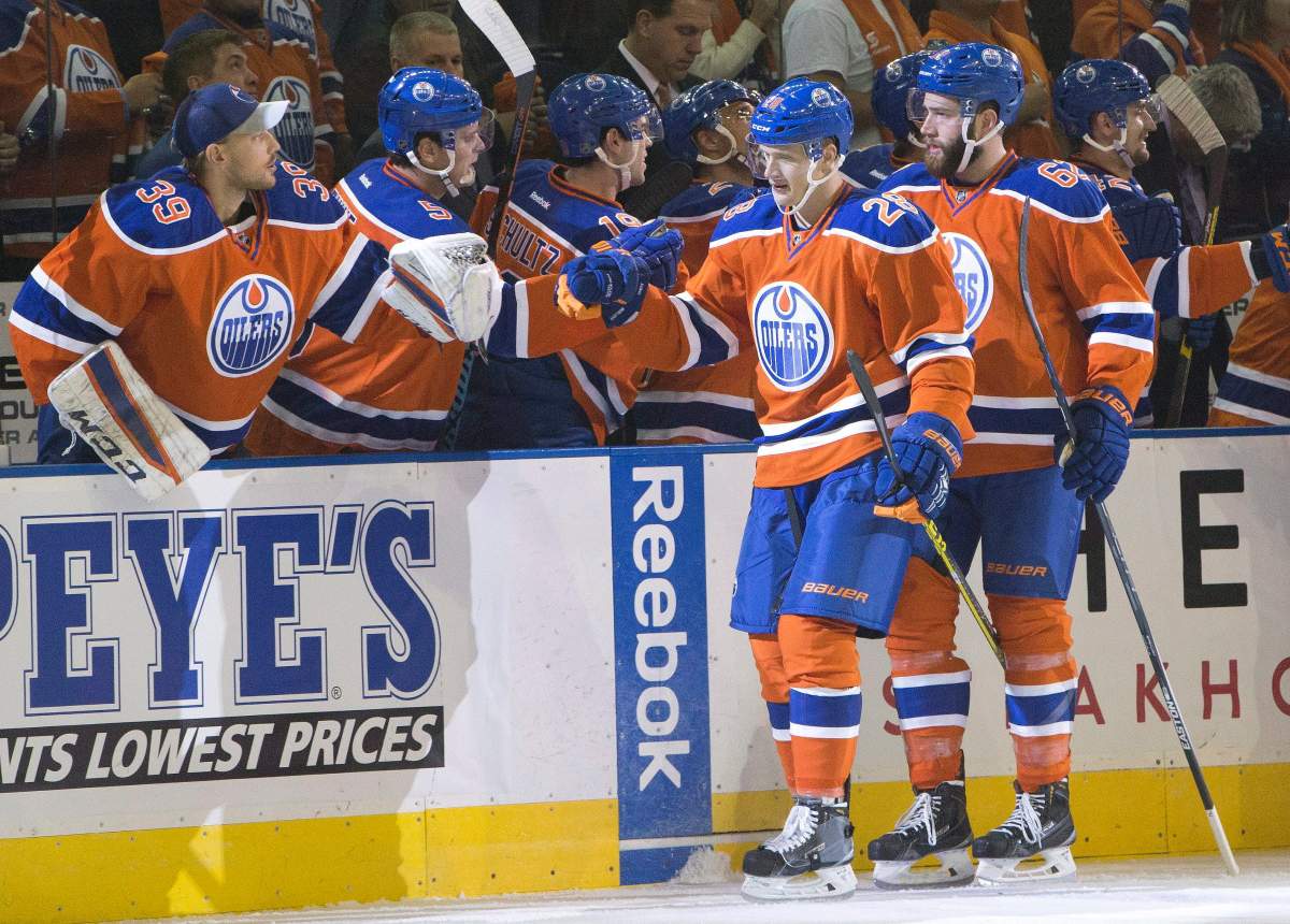 Edmonton Oilers’ Lauri Korpikoski (28) and Eric Gryba (62) celebrate a goal against the St. Louis Blues during first period NHL action in Edmonton, Alta., on Thursday October 15, 2015.