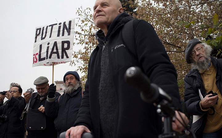 A protester holds a banner during an anti-war rally in Moscow, Russia, Saturday, Oct. 17, 2015. 