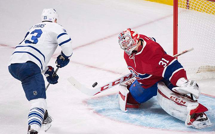 Montreal Canadiens goaltender Carey Price makes a save against Toronto Maple Leafs' Shawn Matthias during first period NHL hockey action in Montreal, Saturday, October 24, 2015. 