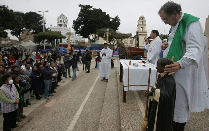 A Catholic priest at mass in the main square in Pisco, Peru.