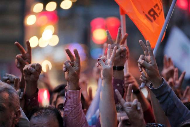 Demonstrators flash the V-sign during a rally to protest against the bombing in Ankara earlier, in central Istanbul, Saturday, Oct. 10, 2015. Thousands of protestors flooded the main street in central Istanbul shouting slogans condemning the twin bombings that killed dozens of people in nation¹s capital. The two bomb explosions targeted a peace rally, that was aimed to call for an end to the renewed violence between Kurdish rebels and Turkish security forces.