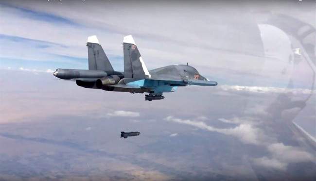 In this file photo made from the footage taken from Russian Defense Ministry official website on Friday, Oct. 9, 2015, a bomb is released from Russian Su-34 strike fighter in Syria.