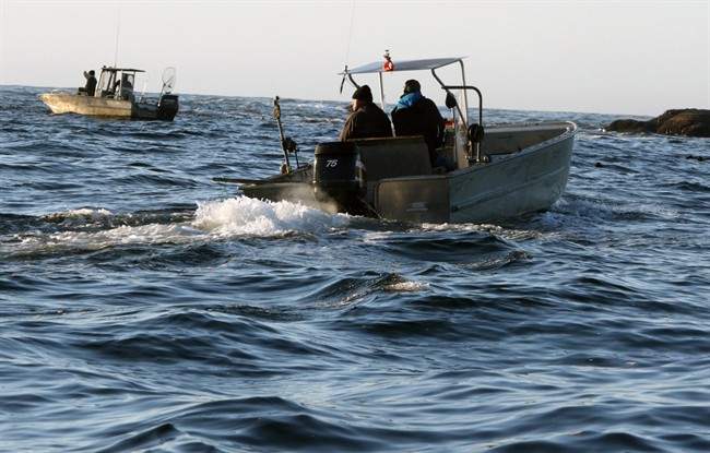 Ahousaht First Nation boats patrol an area near where the whale watching boat Leviathan II sank near Tofino, British Columbia, Monday, Oct. 26, 2015.  