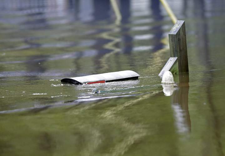A mailbox is nearly submerged in floodwater in a neighborhood near the overflowing Black Creek in Florence, S.C., Monday, Oct. 5, 2015.