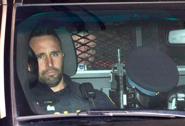 Basil Borutski leaves in a police vehicle after appearing at the courthouse in Pembroke, Ont. on Sept. 23, 2015.