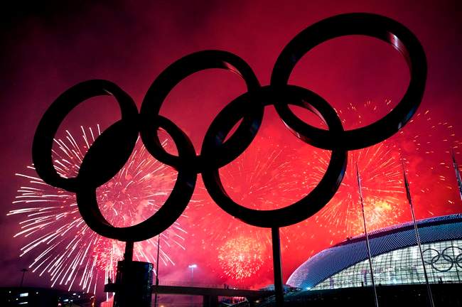The Olympic Rings are silhouetted as fireworks light up the sky during the closing ceremonies at the 2014 Sochi Winter Olympics in Sochi, Russia on Sunday, February 23, 2014.