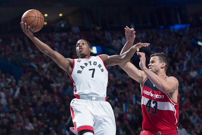 Toronto Raptors' Kyle Lowry jumps to the net as Washington Wizards' Kris Humphries defends during second quarter NBA pre-season basketball action in Montreal on October 23, 2015. THE CANADIAN PRESS/Graham Hughes.