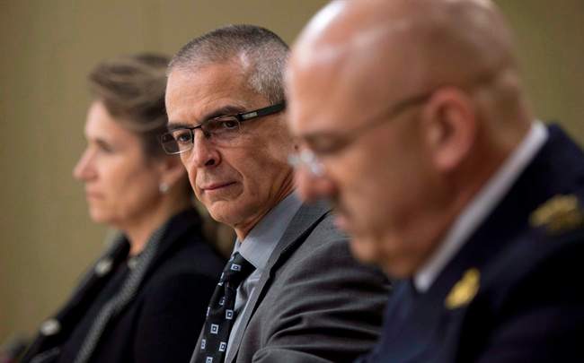 CSIS director Michel Coulombe, centre, waits with RCMP deputy commissioner Mike Cabana, right, and Greta Bossenmaier, Communications Security Establishment chief, to appear at the Senate national security committee to discuss the anti-terrorism act, Bill C-51 in Ottawa, April 20, 2015.