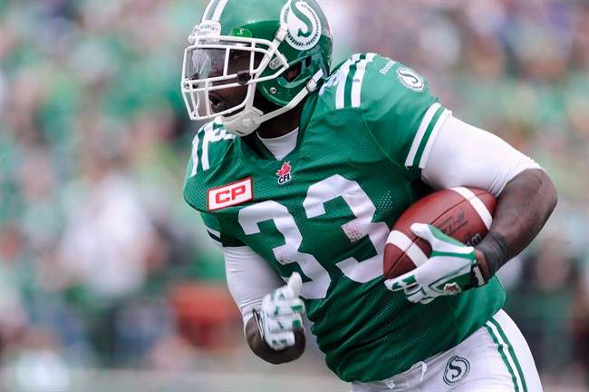 Saskatchewan Roughriders' Jerome Messam runs the ball against the Winnipeg Blue Bombers during second half CFL action in Regina on September 6, 2015. Two weeks of rest followed by a full week of practice with his new team, big running back Jerome Messam says he's ready for his debut as Calgary Stampeder on Saturday. The first team he faces wearing the red and white is the team that traded him - the Saskatchewan Roughriders.