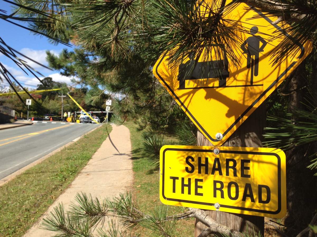 A “share the road” sign is pictured just a few metres from where a cyclist was struck and killed by a propane truck on Wednesday.